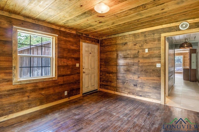 1150 Fm 139, Joaquin, TX 75954 - spare room featuring wood ceiling, wood walls, and dark wood-style flooring