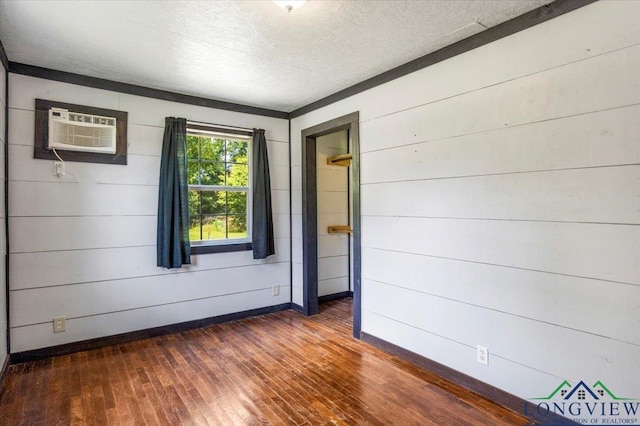 1150 Fm 139, Joaquin, TX 75954 - empty room featuring dark wood finished floors, a textured ceiling, an AC wall unit, and wooden walls