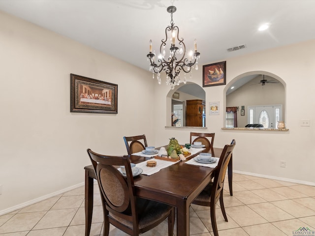 2888 Fm 593, Gilmer, TX 75644 - dining space featuring light tile patterned floors, arched walkways, baseboards, and visible vents