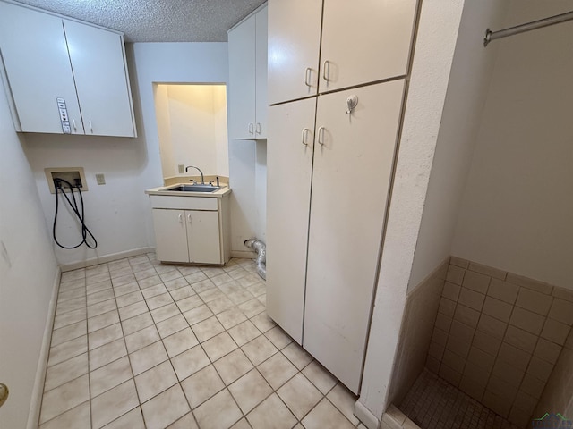 bathroom with a textured ceiling, vanity, and tile patterned floors