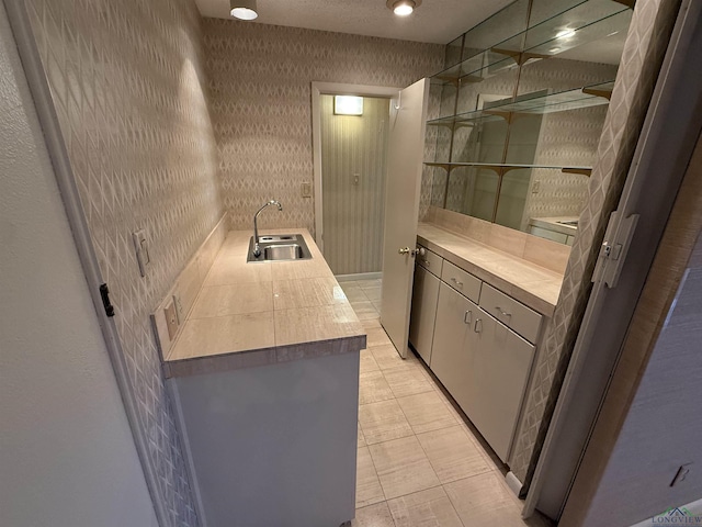 bar featuring sink and light tile patterned floors