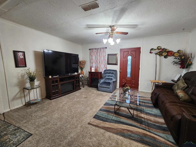 carpeted living room featuring ceiling fan and a textured ceiling