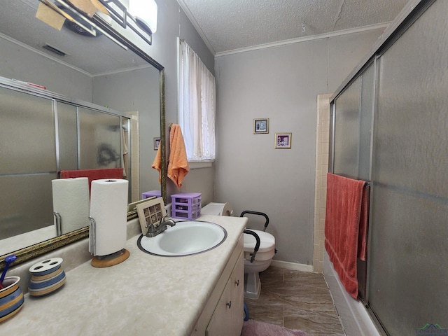 bathroom featuring vanity, an enclosed shower, toilet, crown molding, and a textured ceiling