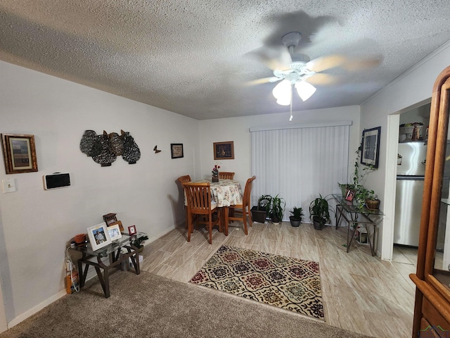 dining space with ceiling fan and a textured ceiling