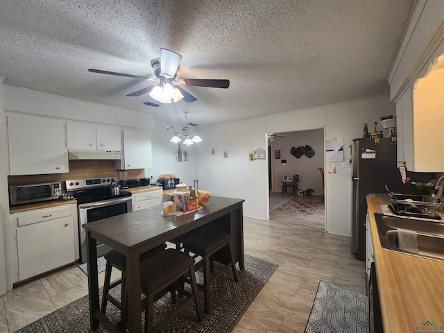 kitchen featuring sink, white cabinetry, a textured ceiling, appliances with stainless steel finishes, and ceiling fan