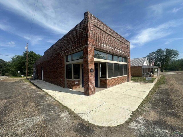 view of property exterior with brick siding