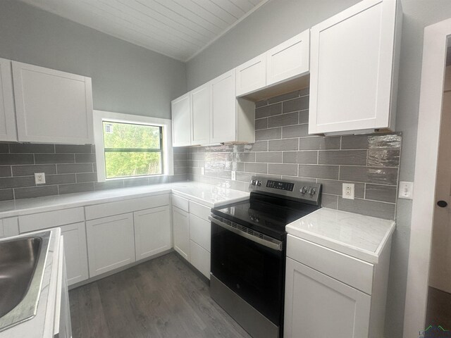 kitchen with stainless steel range with electric cooktop, a sink, light countertops, white cabinetry, and dark wood-type flooring
