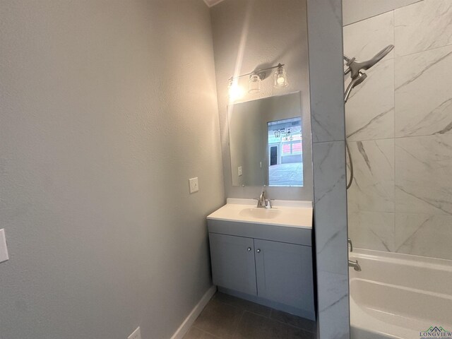 full bathroom featuring vanity, baseboards, bathtub / shower combination, and tile patterned floors