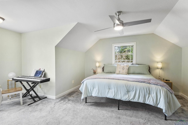 carpeted bedroom featuring baseboards, vaulted ceiling, and ceiling fan