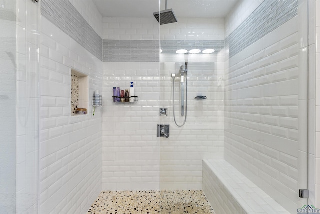 full bathroom with a tile shower