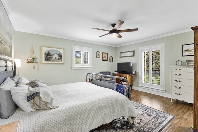bedroom featuring ornamental molding, ceiling fan, wood finished floors, and multiple windows