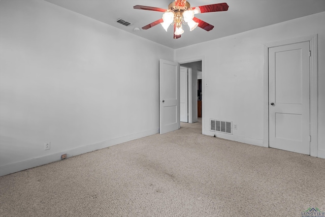 spare room featuring light carpet and ceiling fan