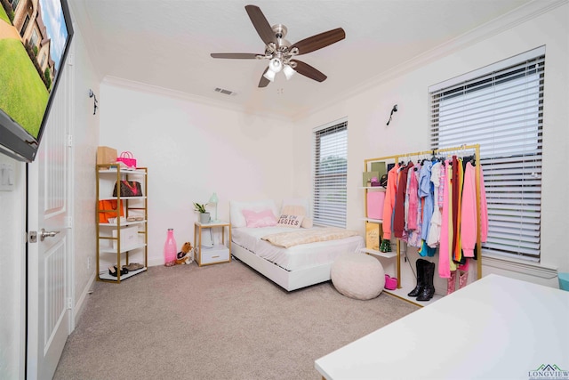 bedroom featuring visible vents, crown molding, ceiling fan, carpet floors, and baseboards