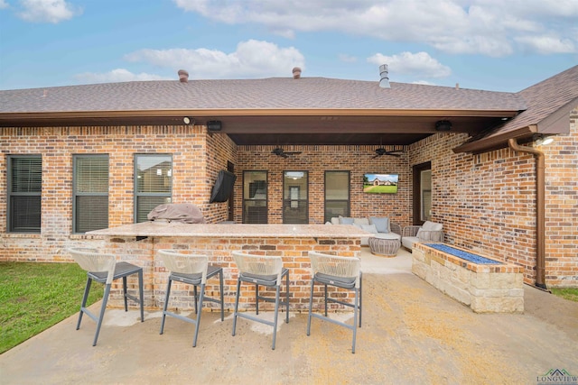 view of patio with a grill, ceiling fan, and outdoor wet bar