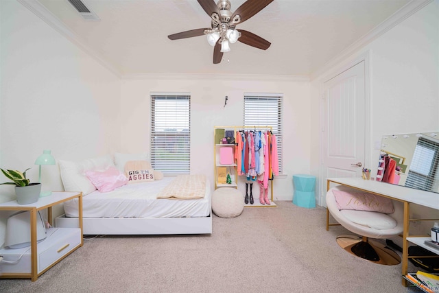 carpeted bedroom featuring ceiling fan, ornamental molding, and visible vents