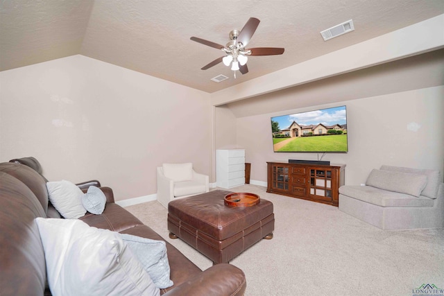 carpeted living room with a ceiling fan, lofted ceiling, visible vents, and a textured ceiling