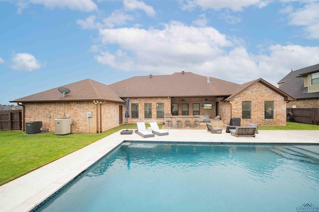 view of pool featuring outdoor dry bar, a patio, a fenced backyard, a fenced in pool, and a lawn