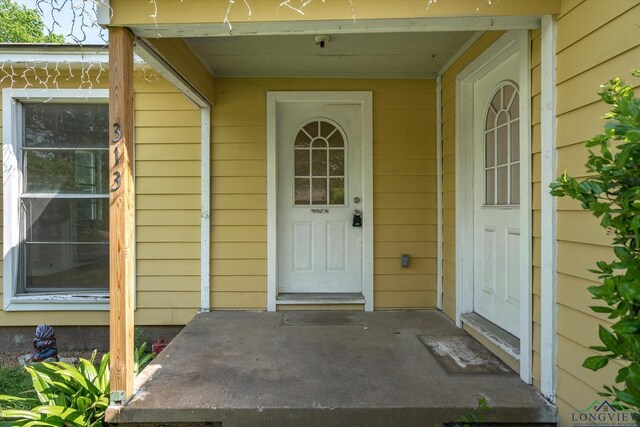 view of exterior entry featuring a porch