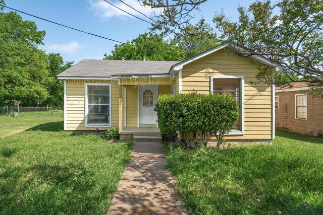 view of front of property with fence and a front yard