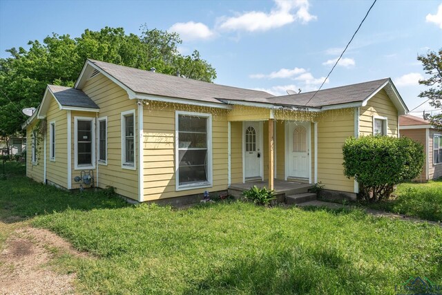 bungalow-style home featuring a front yard