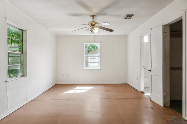 empty room with visible vents, a ceiling fan, and a healthy amount of sunlight