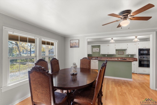 dining room with ceiling fan, light hardwood / wood-style floors, and ornamental molding