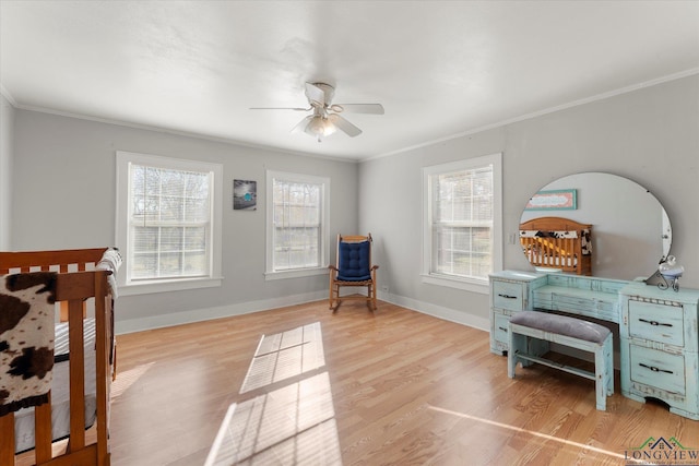 bedroom with ornamental molding, light hardwood / wood-style flooring, and multiple windows