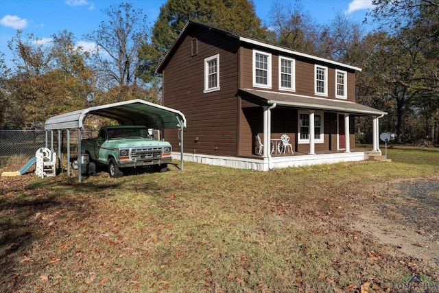 view of front of home featuring a carport, covered porch, and a front lawn