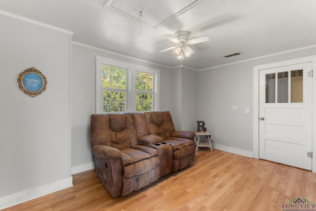 living area with ceiling fan, light hardwood / wood-style floors, and ornamental molding