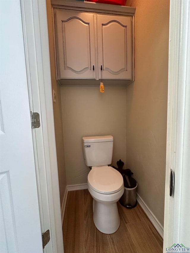 107 Kelly Ct, Marshall, TX 75672 - bathroom with toilet, wood finished floors, and baseboards