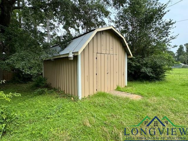 view of outbuilding with a yard