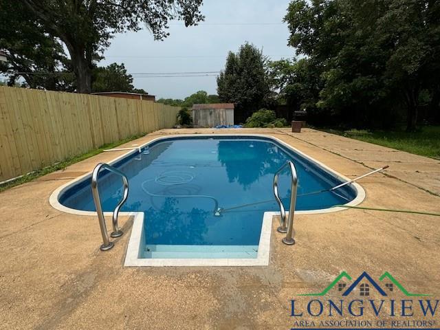 view of pool with a fenced in pool, a fenced backyard, and a patio area