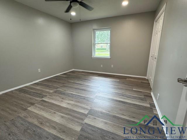 spare room featuring ceiling fan and dark hardwood / wood-style flooring