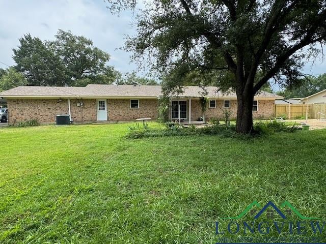 back of property featuring a yard and cooling unit