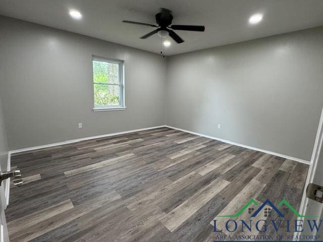 spare room featuring ceiling fan and dark wood-type flooring