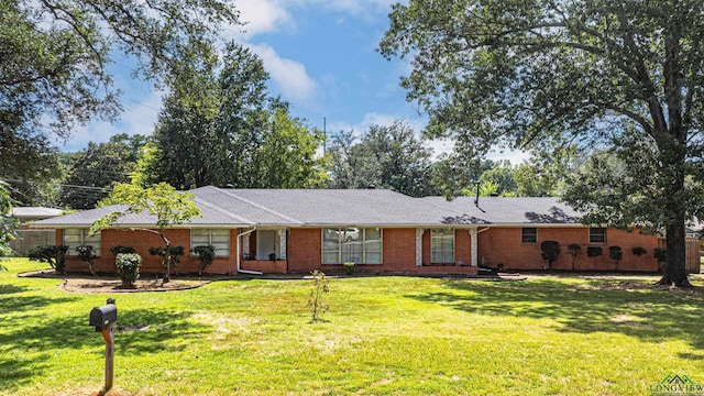 2215 Redbud, Kilgore, TX 75662 - ranch-style house featuring a front yard and brick siding