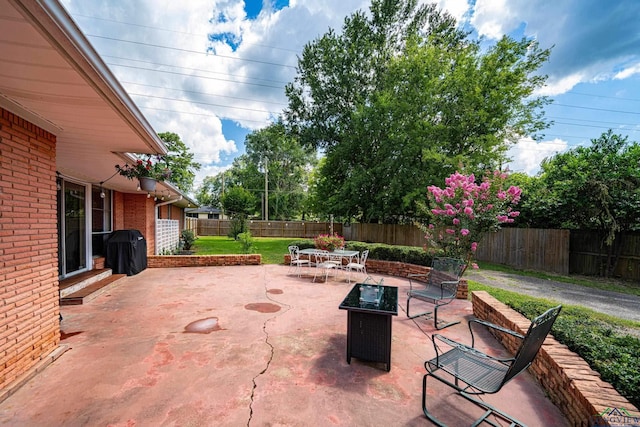 2215 Redbud, Kilgore, TX 75662 - fenced backyard with a patio and outdoor dining space