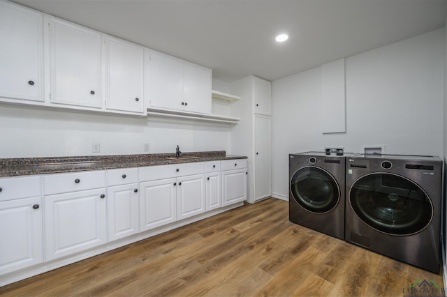 22551 Pine St, Frankston, TX 75763 - laundry room with washer and dryer, light wood finished floors, cabinet space, and recessed lighting
