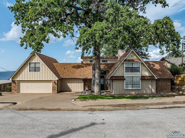 22551 Pine St, Frankston, TX 75763 - view of front of property with concrete driveway, a garage, a chimney, roof with shingles, and brick siding