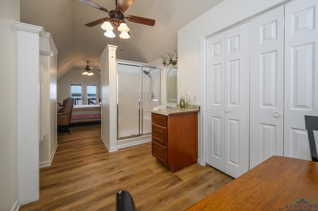 22551 Pine St, Frankston, TX 75763 - full bath featuring a ceiling fan, vaulted ceiling, a closet, a stall shower, and wood finished floors
