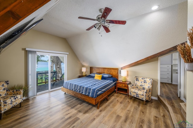 22551 Pine St, Frankston, TX 75763 - bedroom with access to exterior, lofted ceiling, wood finished floors, a textured ceiling, and recessed lighting