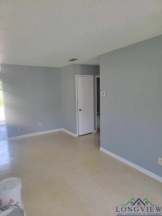 empty room featuring a textured ceiling