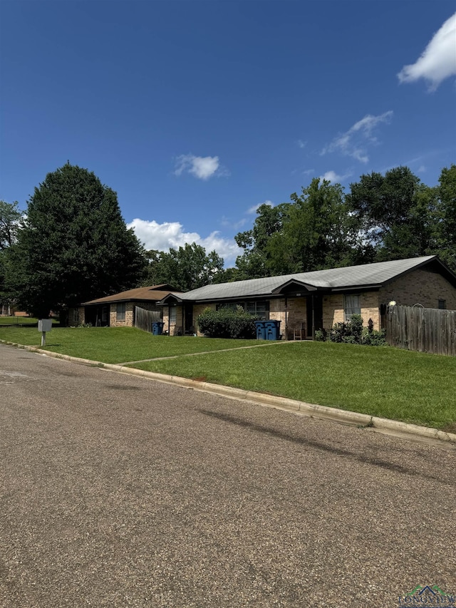 ranch-style house with a front lawn