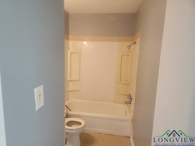 bathroom with tile patterned flooring,  shower combination, and toilet