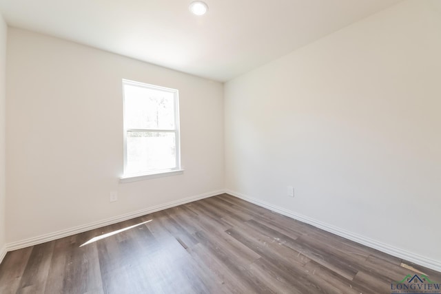 801 W Walnut St, Longview, TX 75601 - unfurnished room with wood finished floors and baseboards