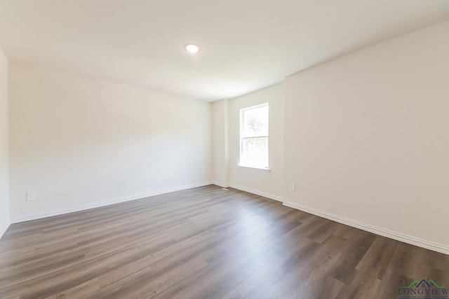 801 W Walnut St, Longview, TX 75601 - spare room with dark wood-style floors, baseboards, and recessed lighting