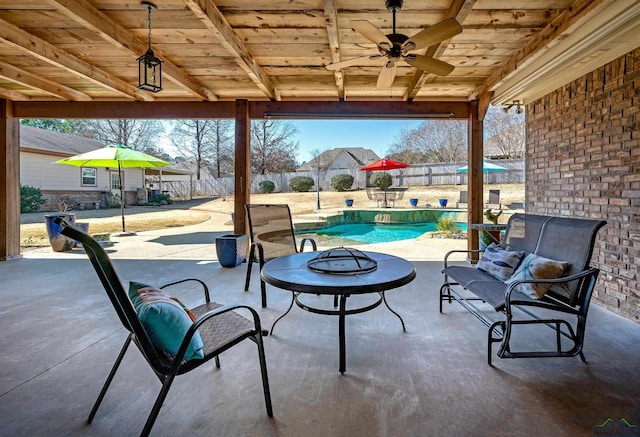 view of patio featuring a fenced in pool and ceiling fan