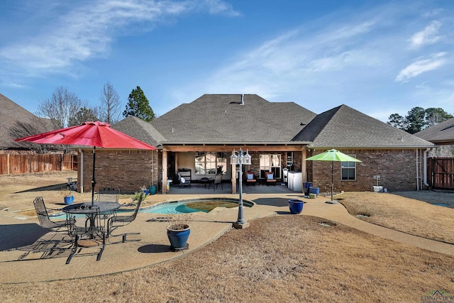 back of property featuring a fenced in pool and a patio area