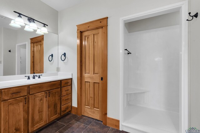 unfurnished bedroom with ceiling fan, light colored carpet, sink, and ensuite bath