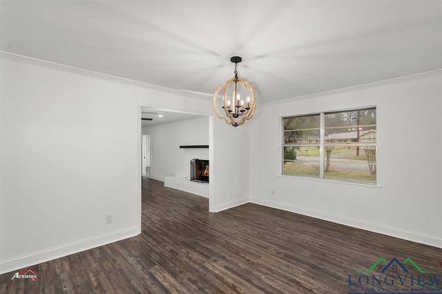 interior space featuring dark hardwood / wood-style flooring, crown molding, and a chandelier